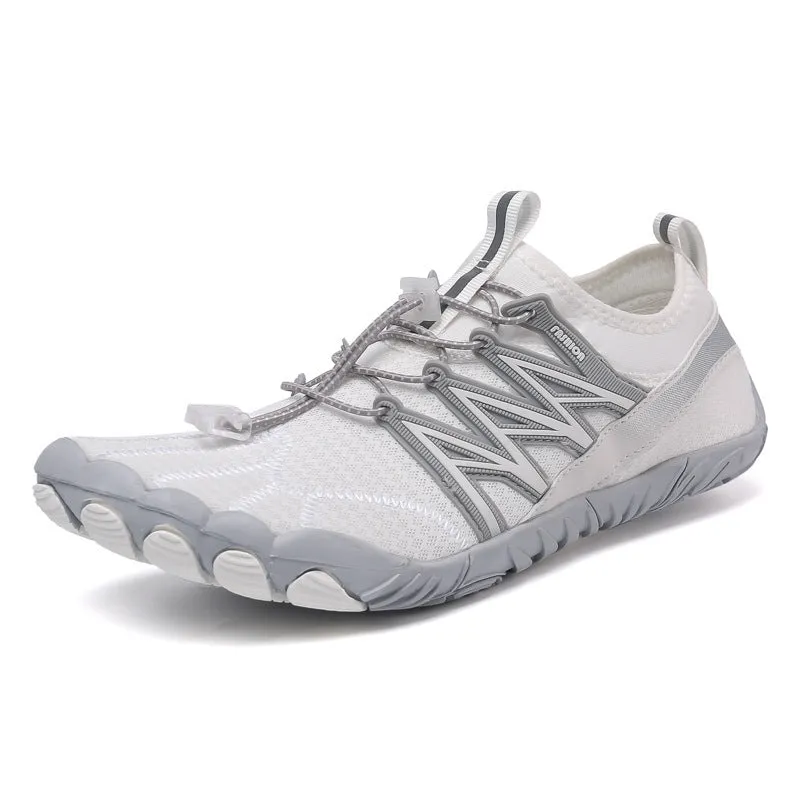 Low-top striped training sneakers with a flat rubber sole, shown in various colours including black and grey orange.