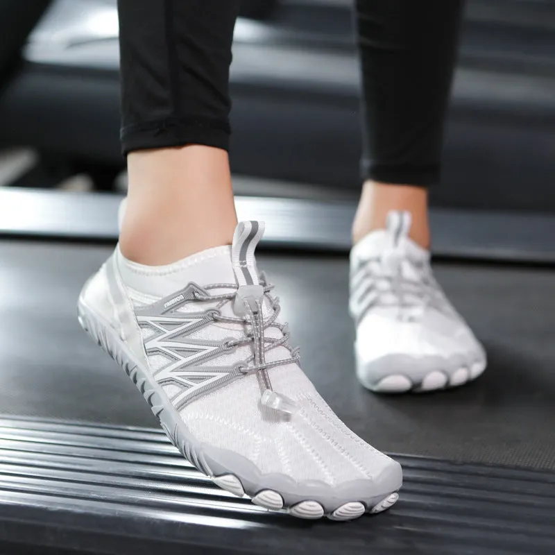 Low-top striped training sneakers with a flat rubber sole, shown in various colours including black and grey orange.