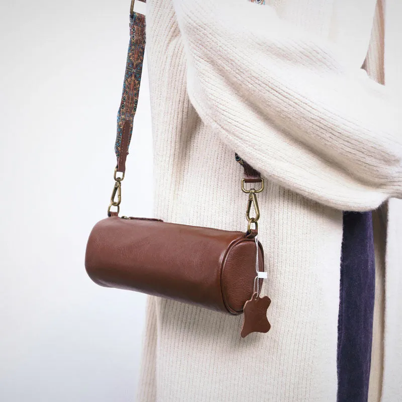 Top layer cowhide leather round single-shoulder bag in caramel brown with wide strap and sewing thread details