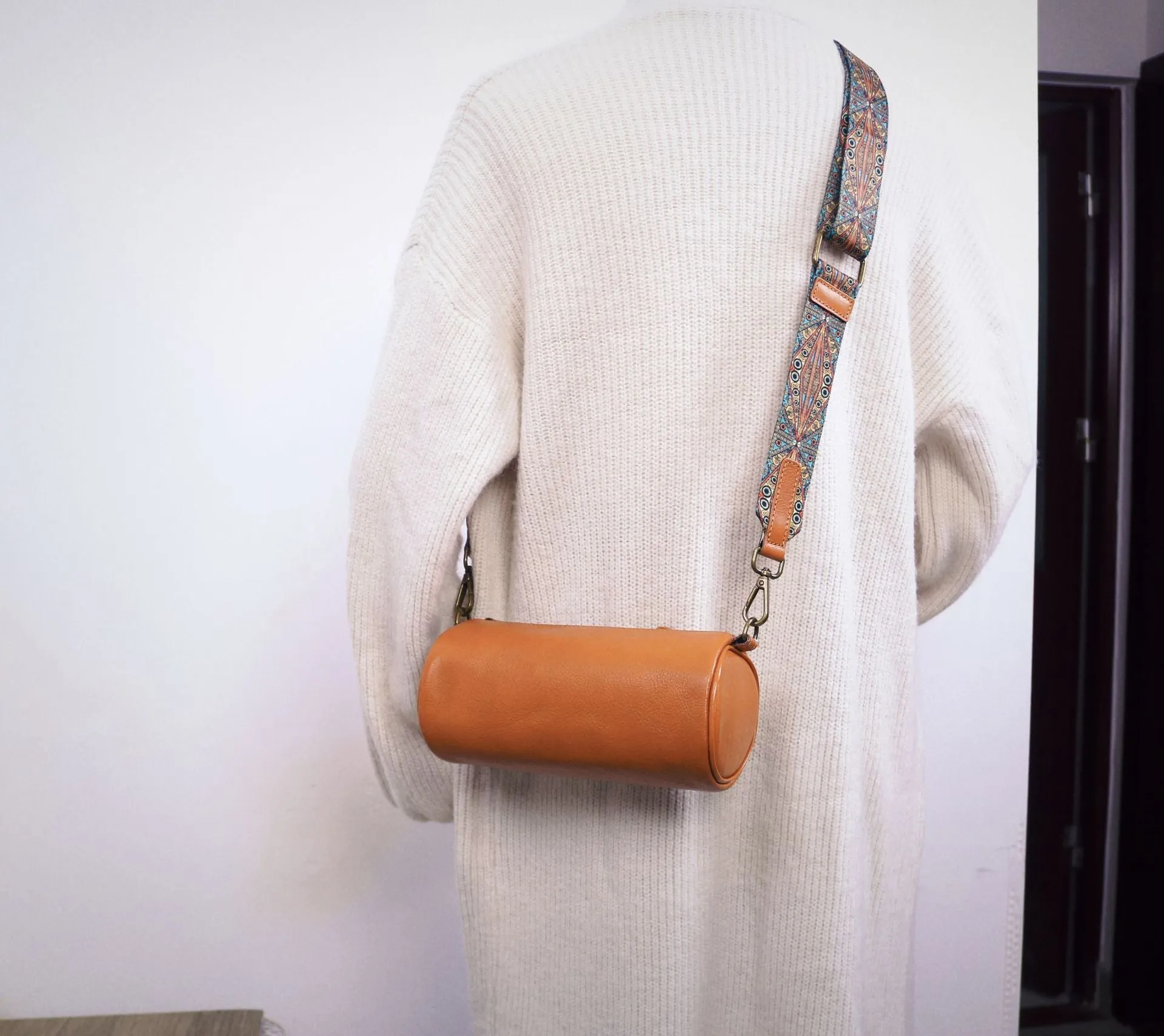 Top layer cowhide leather round single-shoulder bag in caramel brown with wide strap and sewing thread details
