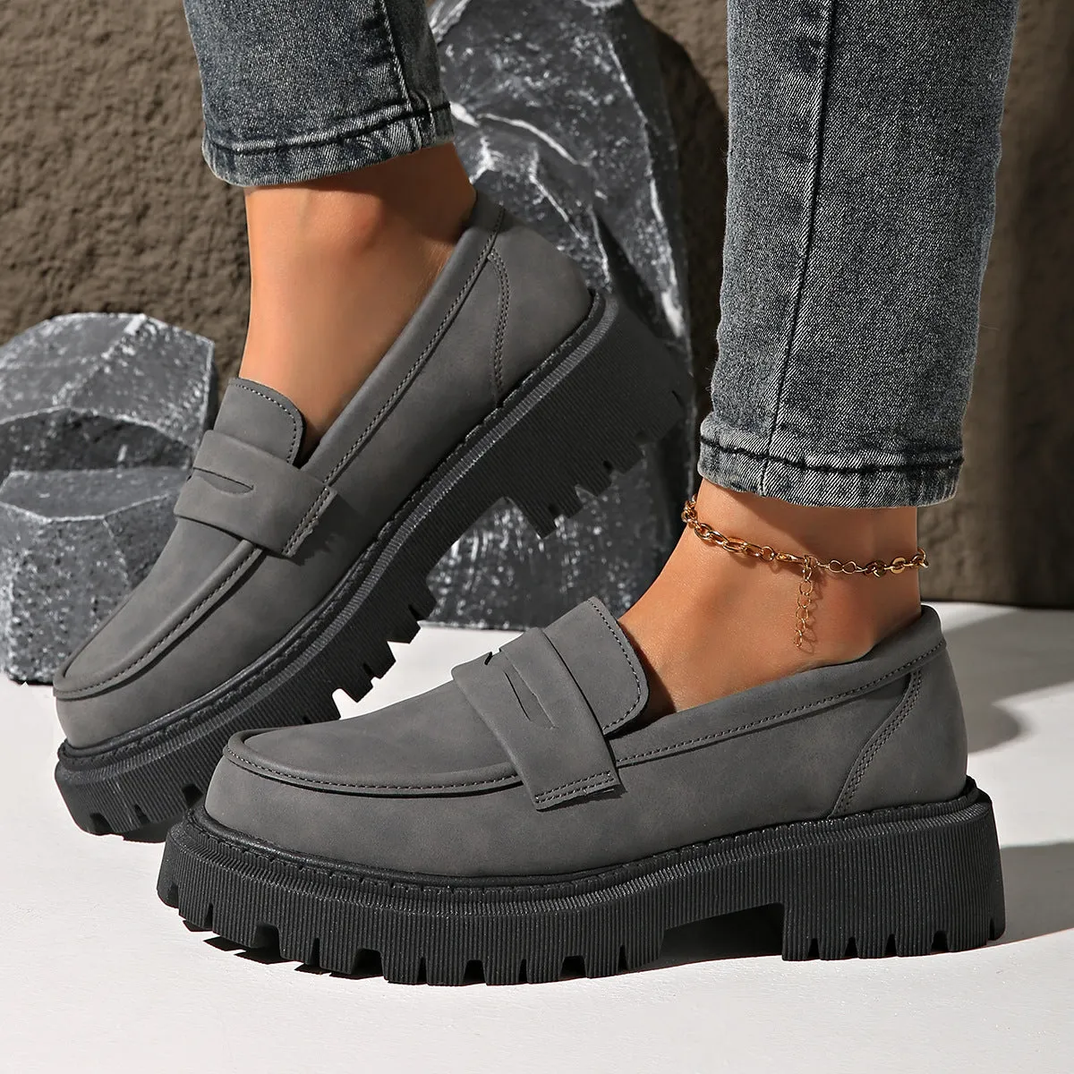 Gray British style slip-on low cut loafers with low heel and rubber sole