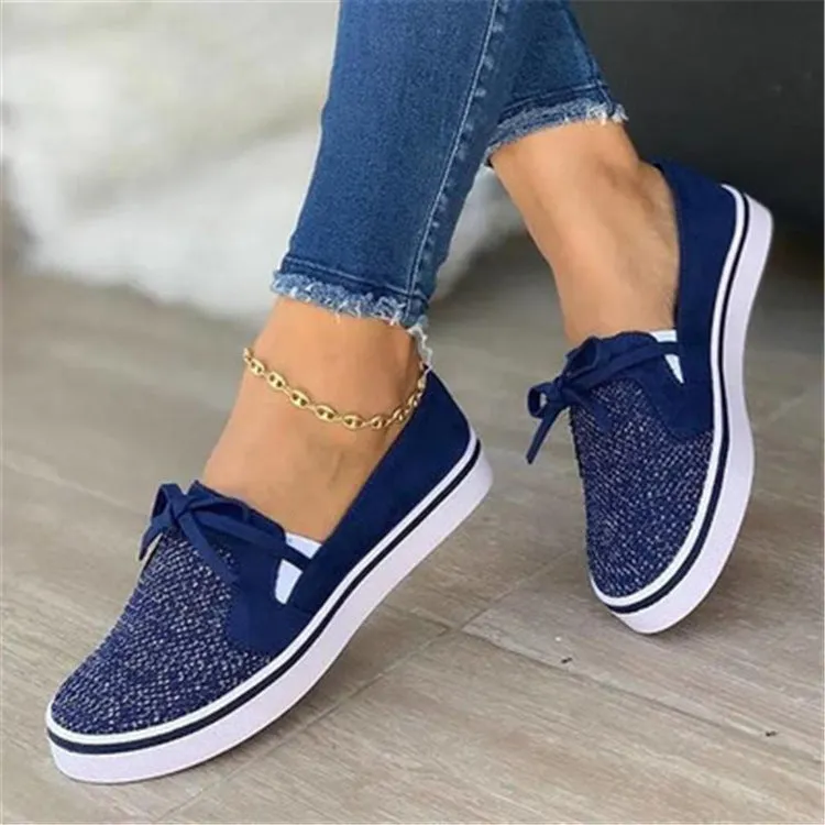 White canvas lace-up flat shoes for women with cross strap design and round toe