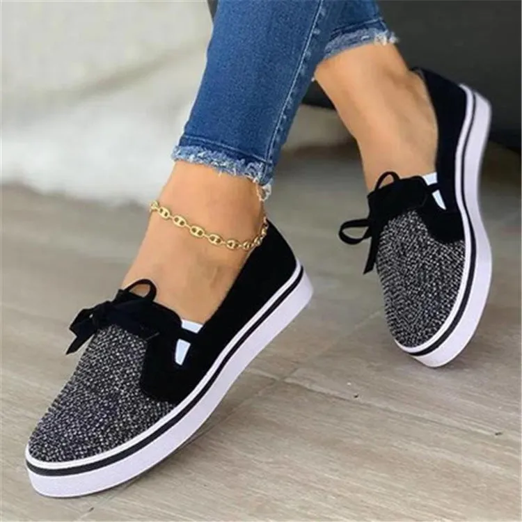 White canvas lace-up flat shoes for women with cross strap design and round toe