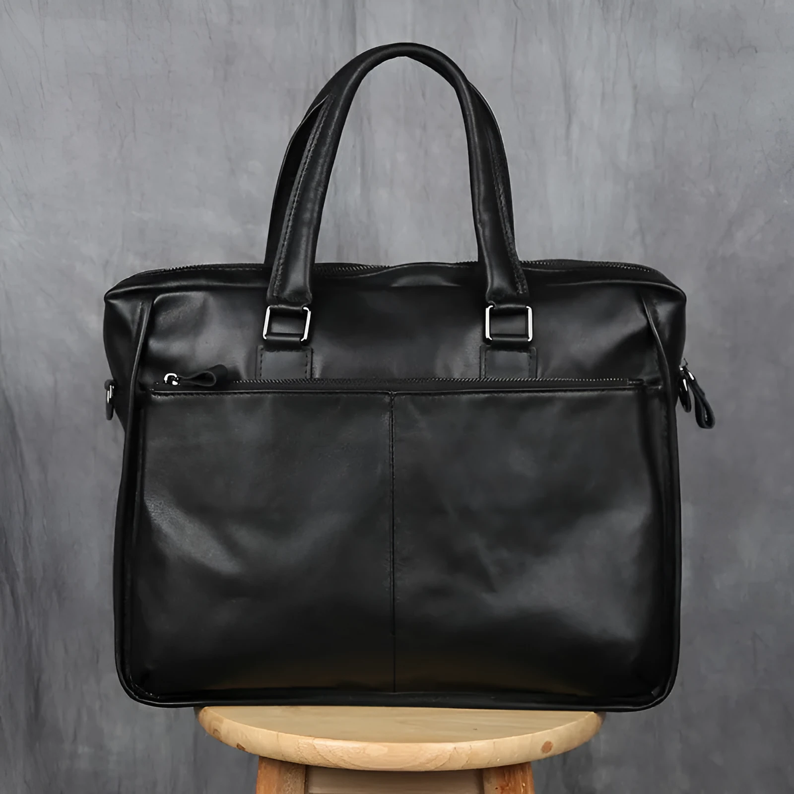Black men's leather leisure briefcase with top layer cow hide, zipper closure, and shoulder strap