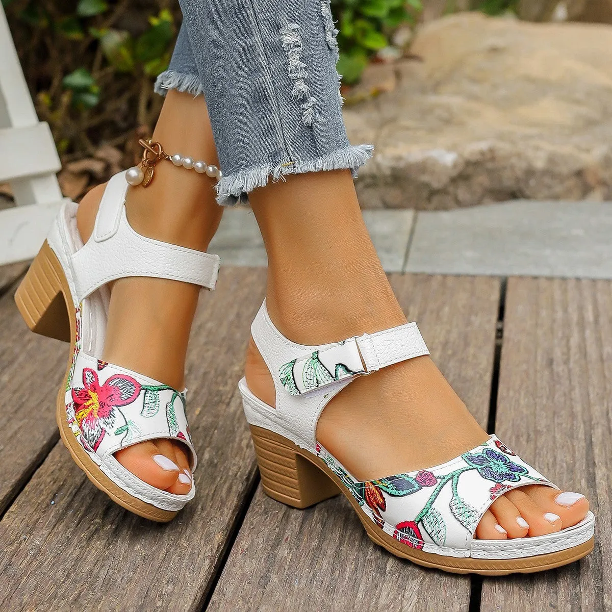 White women's high heel sandals with velcro buckle closure showing rubber sole