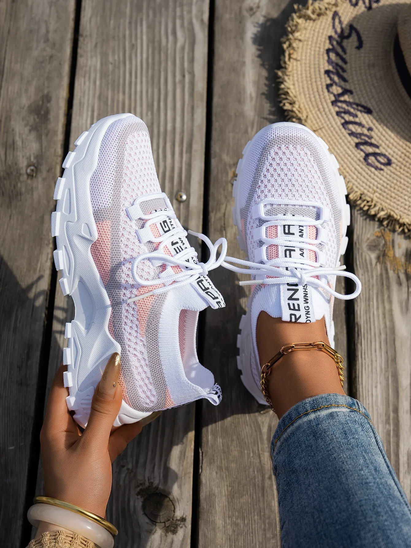 Women's Flyknit mesh lace-up sneakers in a grey colourway with a round toe and flat rubber sole.