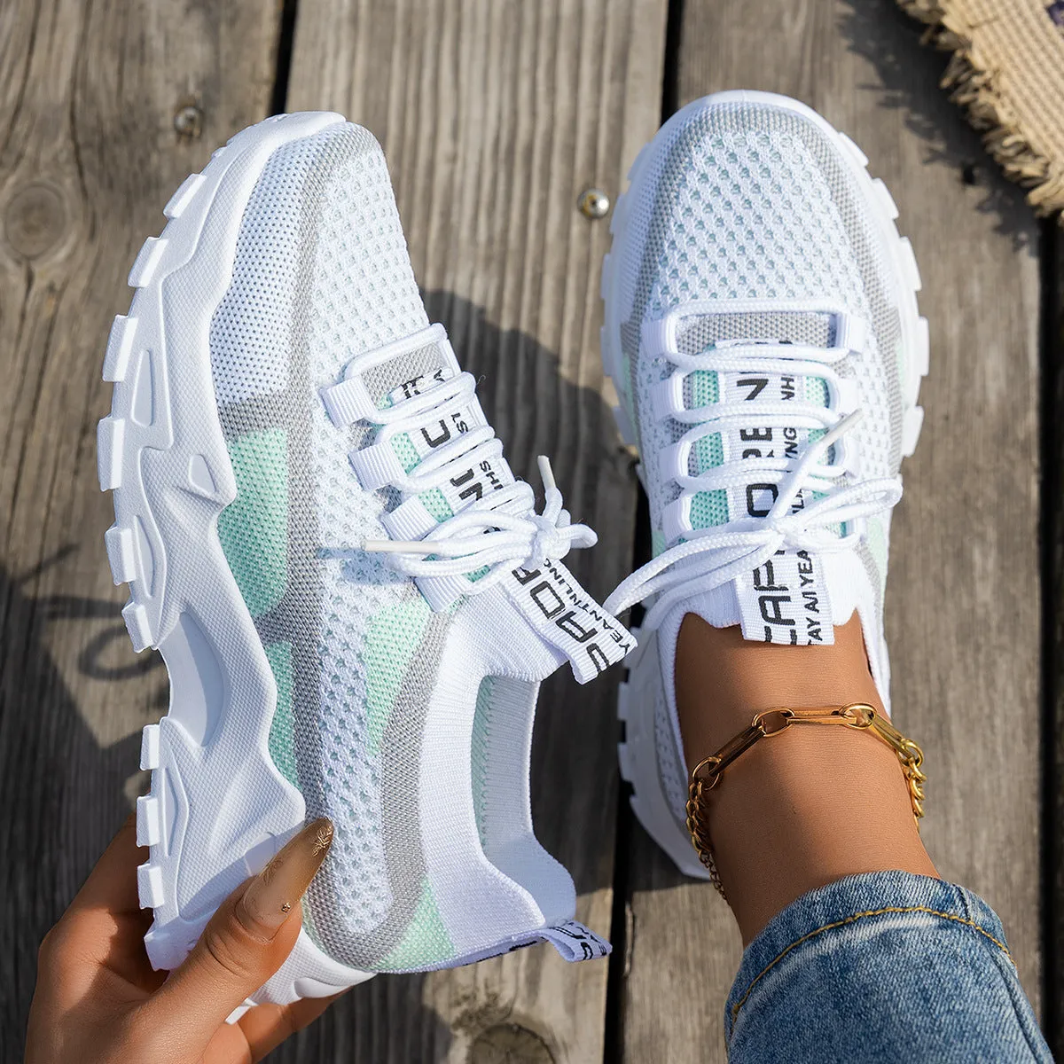 Women's Flyknit mesh lace-up sneakers in a grey colourway with a round toe and flat rubber sole.