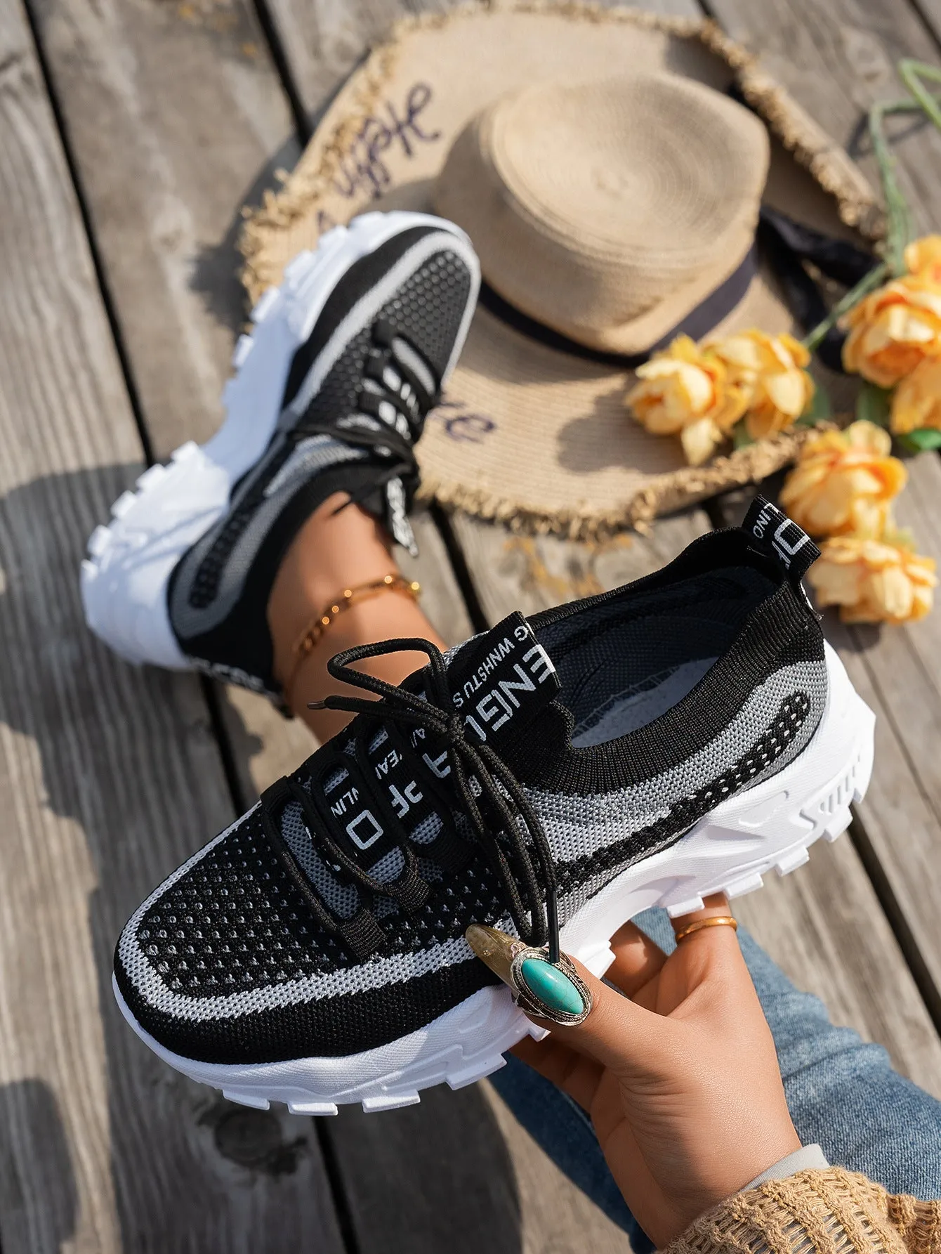 Women's Flyknit mesh lace-up sneakers in a grey colourway with a round toe and flat rubber sole.
