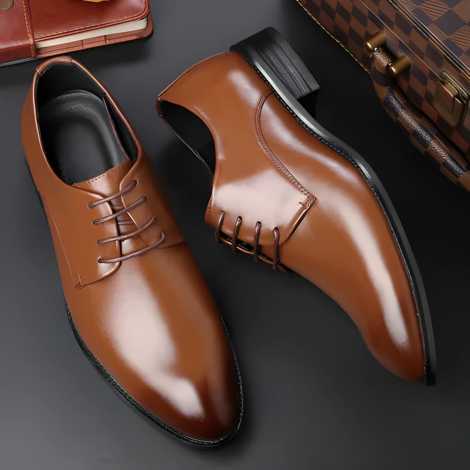Men's black leather dress shoes with low heel and front strap on white background