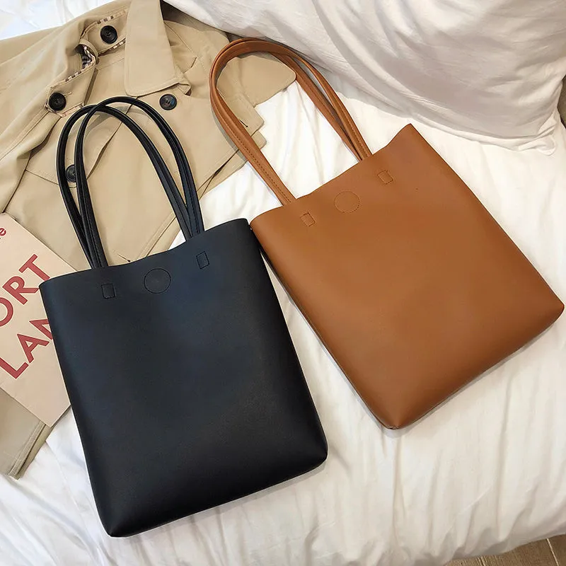 Large-capacity portable tote bag in Black with plain car suture design, soft handle, and single shoulder strap