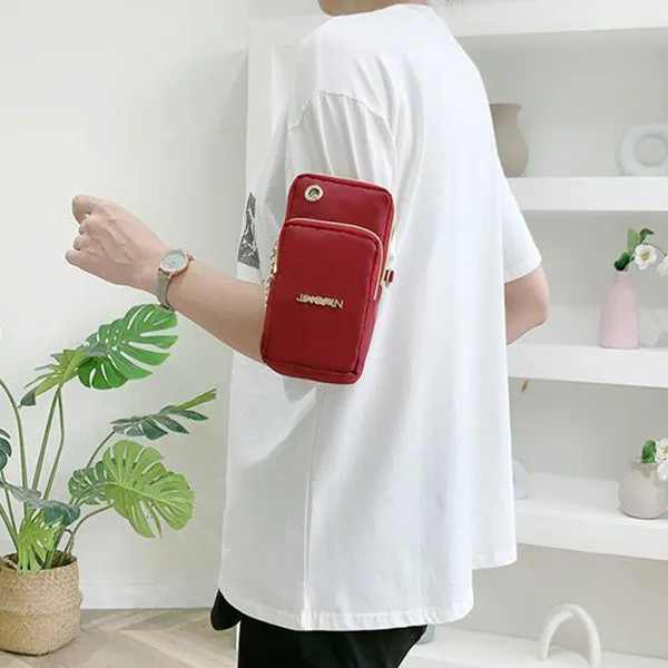 Nylon crossbody mobile phone bag with three zippered layers, card slots, and an adjustable strap in black