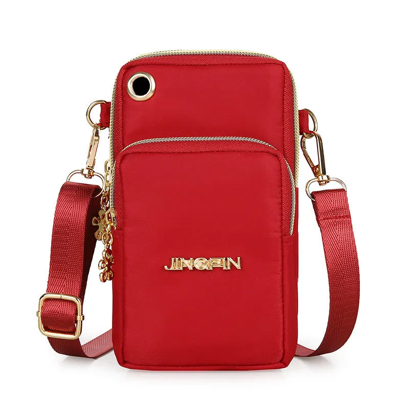 Nylon crossbody mobile phone bag with three zippered layers, card slots, and an adjustable strap in black