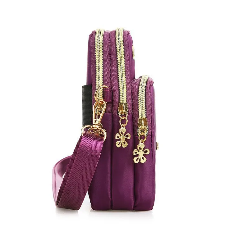 Nylon crossbody mobile phone bag with three zippered layers, card slots, and an adjustable strap in black