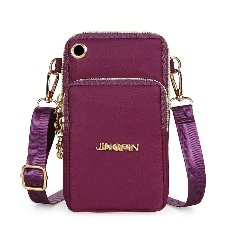 Nylon crossbody mobile phone bag with three zippered layers, card slots, and an adjustable strap in black