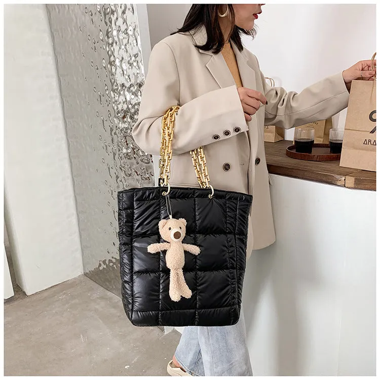 Thick chain tote bag for women in black with zipper closure and single shoulder strap, vertical shape