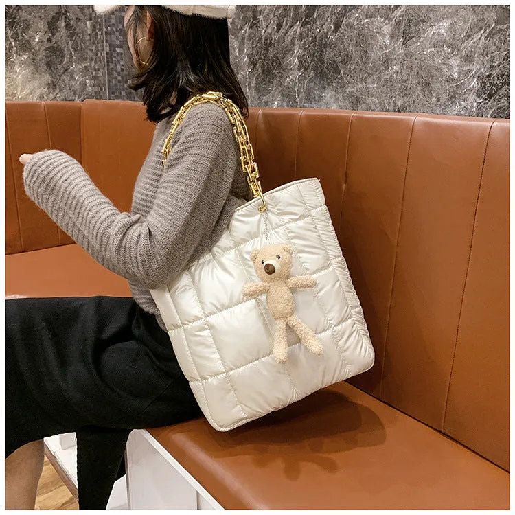 Thick chain tote bag for women in black with zipper closure and single shoulder strap, vertical shape