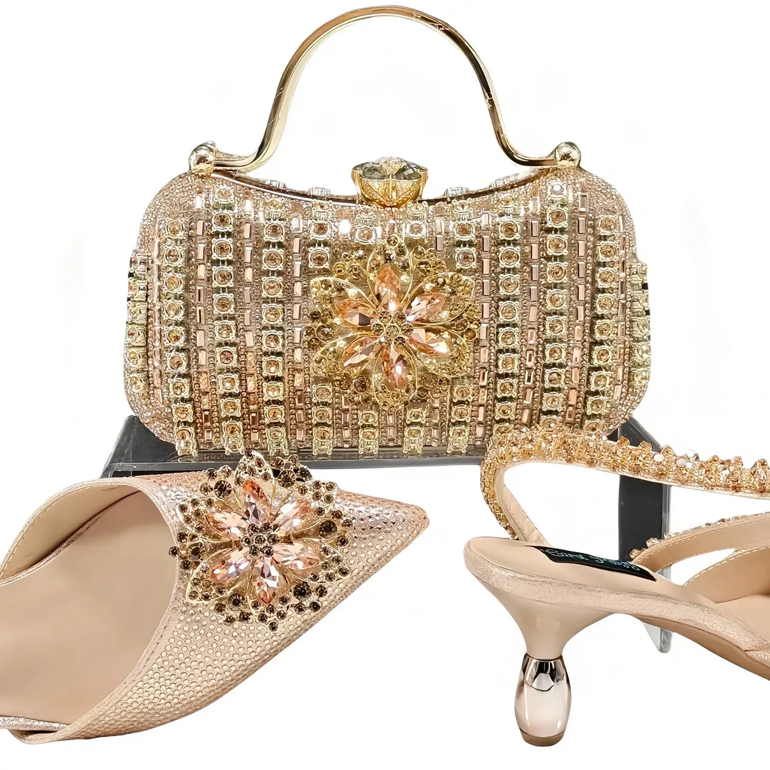 Women's black high-heel ankle strap sandal with rhinestone flower buckle and matching hard clutch bag.