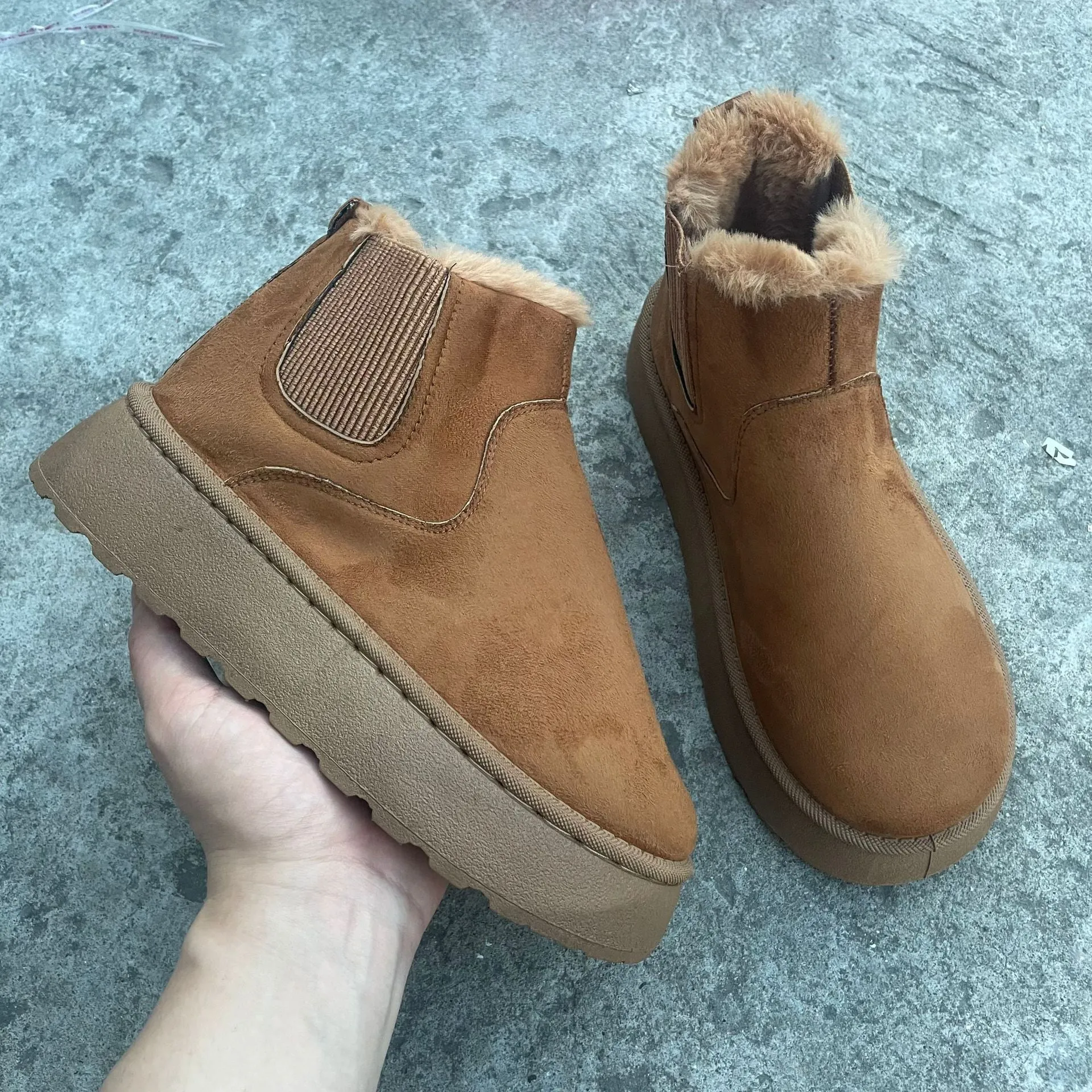 Women's winter snow boots in round toe style with thick rubber sole, cotton fabric upper, and velvet inner lining