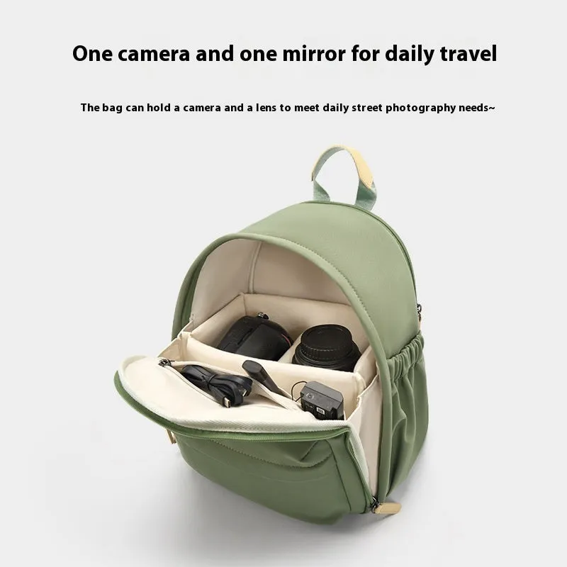 Green polyester shoulder camera bag for women with a curved strap and front patchwork panel.