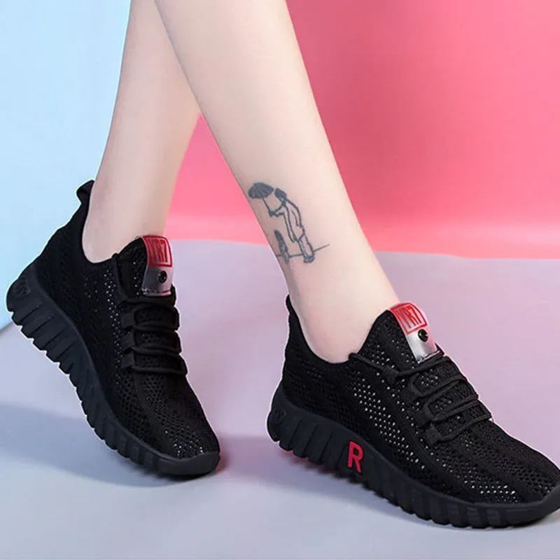 Women's white canvas sports casual shoes with rubber sole, round toe, and low heel, side view