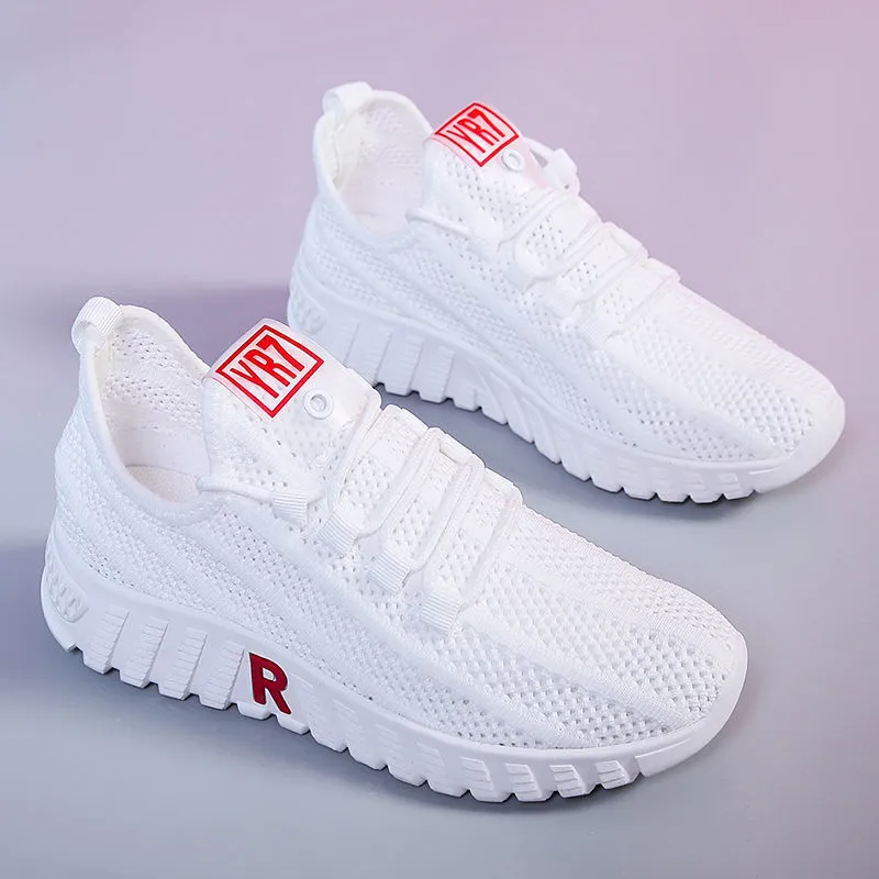 Women's white canvas sports casual shoes with rubber sole, round toe, and low heel, side view