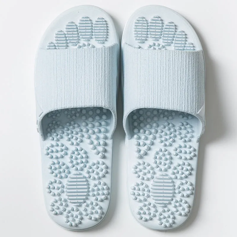 Pair of reflexology foot massage slippers with 3D acupressure particles, blue colour, on a light background