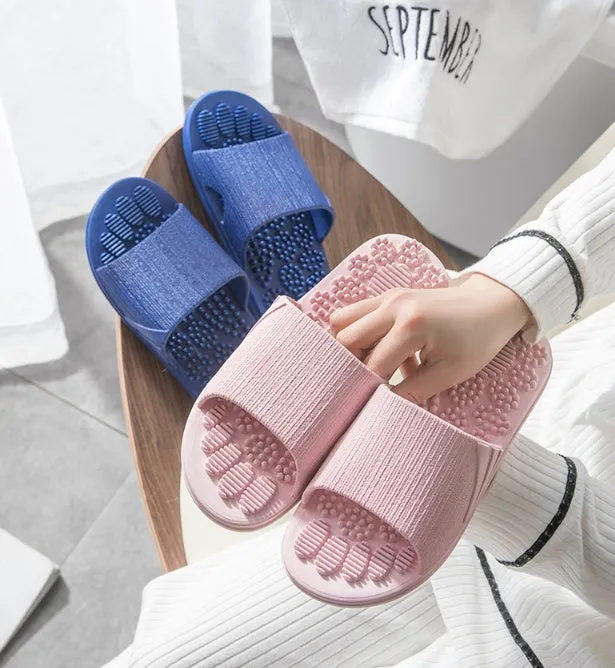 Pair of reflexology foot massage slippers with 3D acupressure particles, blue colour, on a light background