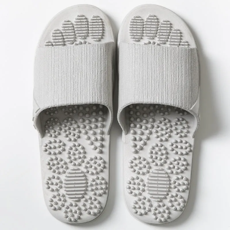 Pair of reflexology foot massage slippers with 3D acupressure particles, blue colour, on a light background