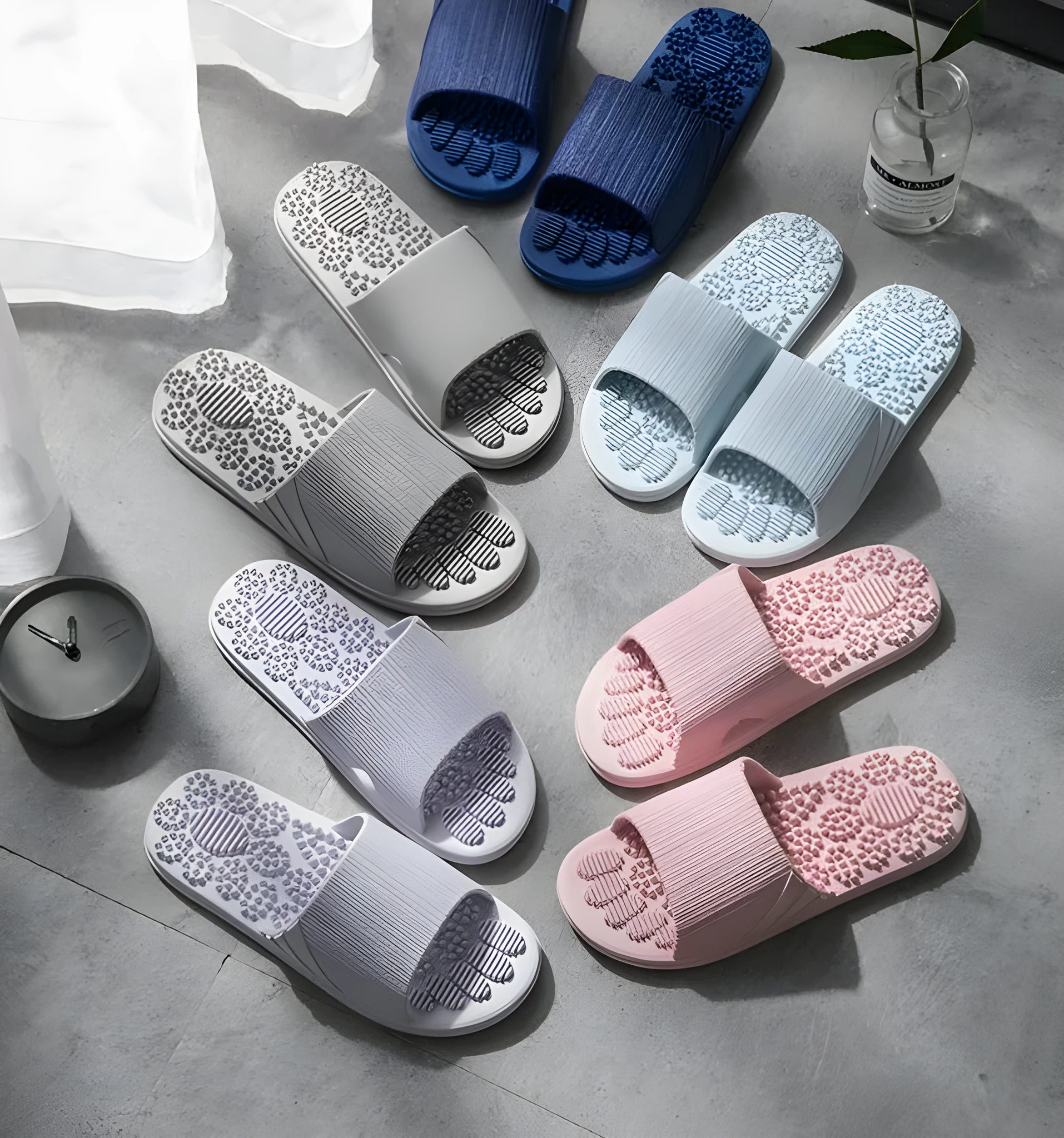 Pair of reflexology foot massage slippers with 3D acupressure particles, blue colour, on a light background