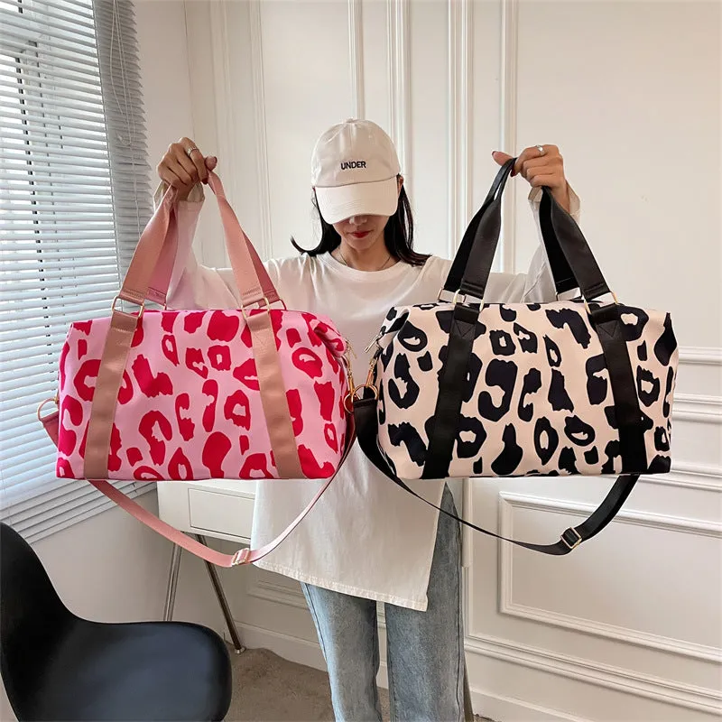 Women's large travel duffel bag with cow pattern, black, showing zippered main compartment and soft handle