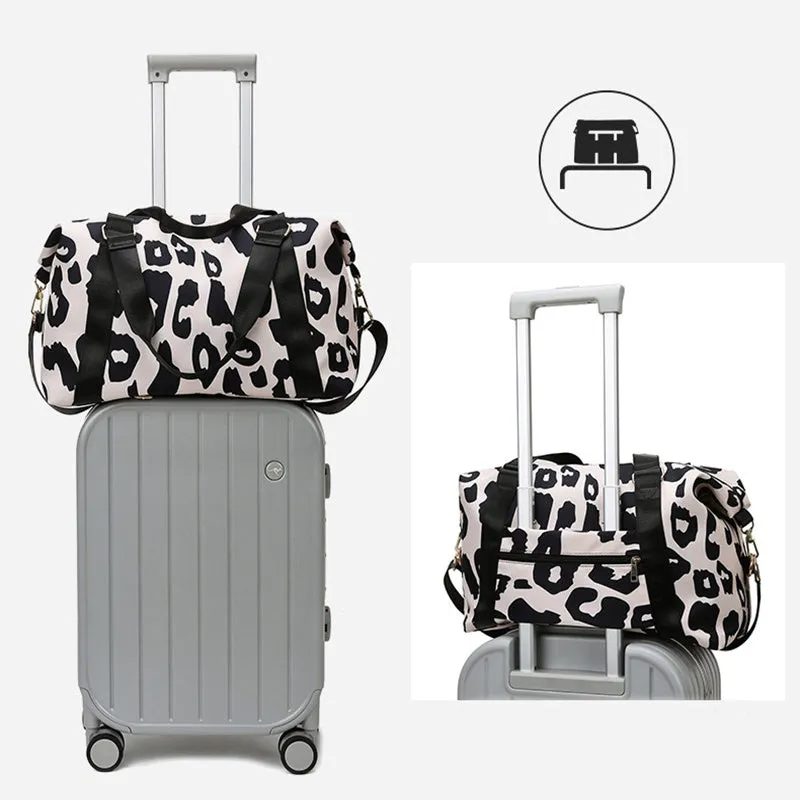 Women's large travel duffel bag with cow pattern, black, showing zippered main compartment and soft handle