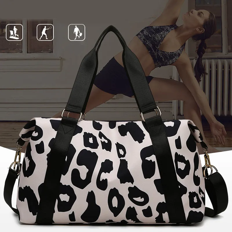 Women's large travel duffel bag with cow pattern, black, showing zippered main compartment and soft handle