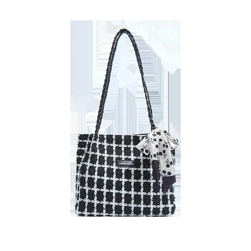 Black woven wool shoulder bag with horizontal square shape showing internal organiser compartments