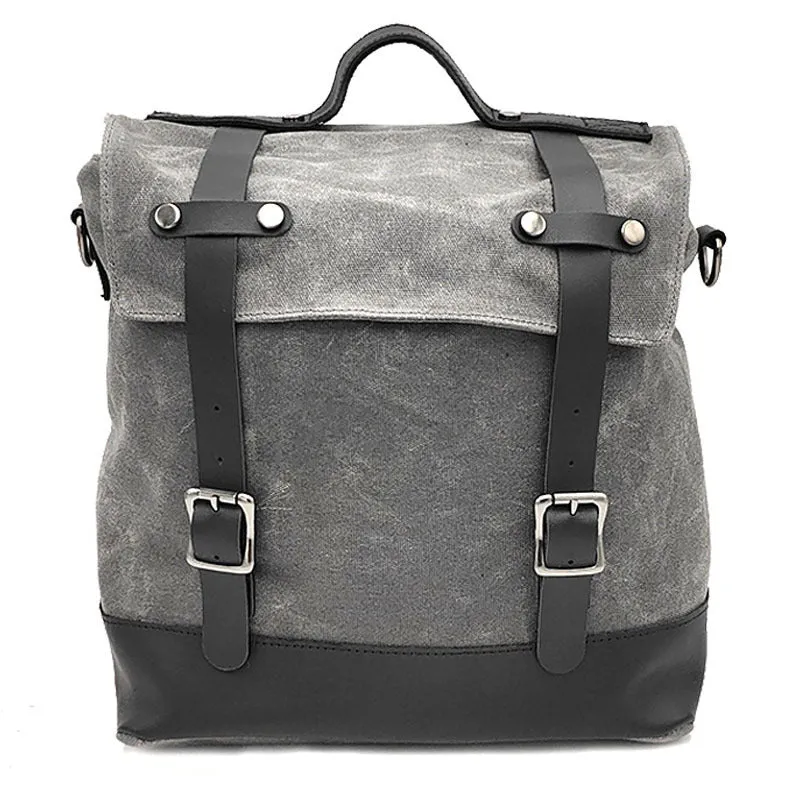 Black waterproof canvas motorcycle side bag with cowhide trim mounted on a bike