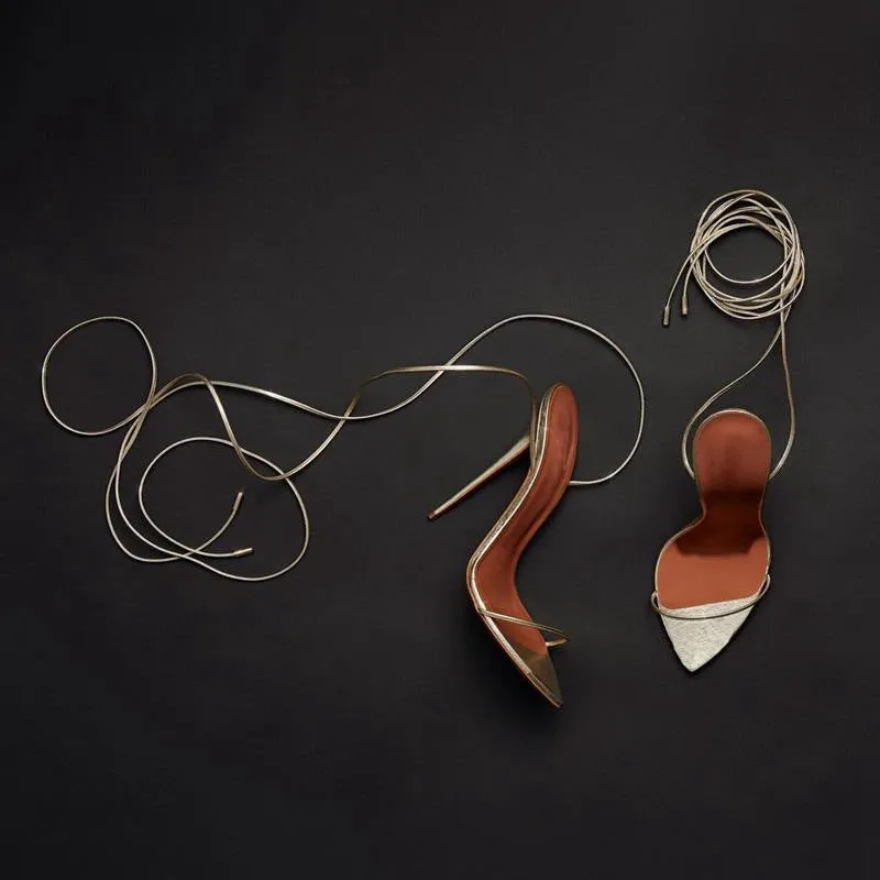 Gold women's ankle strap stiletto sandals with pointed toe and side air detail