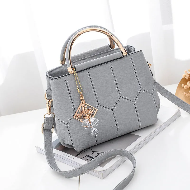 Women's polyester shoulder bag in solid colour with car seam detail and zipper closure, available in five colours