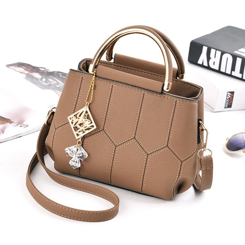 Women's polyester shoulder bag in solid colour with car seam detail and zipper closure, available in five colours