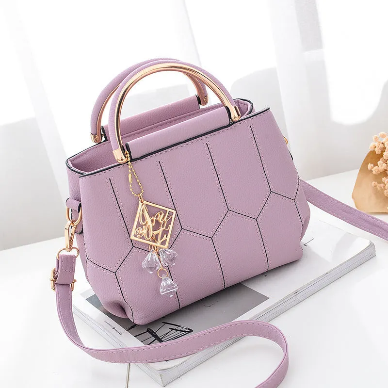 Women's polyester shoulder bag in solid colour with car seam detail and zipper closure, available in five colours