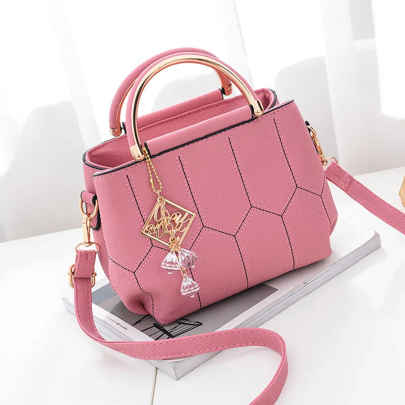 Women's polyester shoulder bag in solid colour with car seam detail and zipper closure, available in five colours