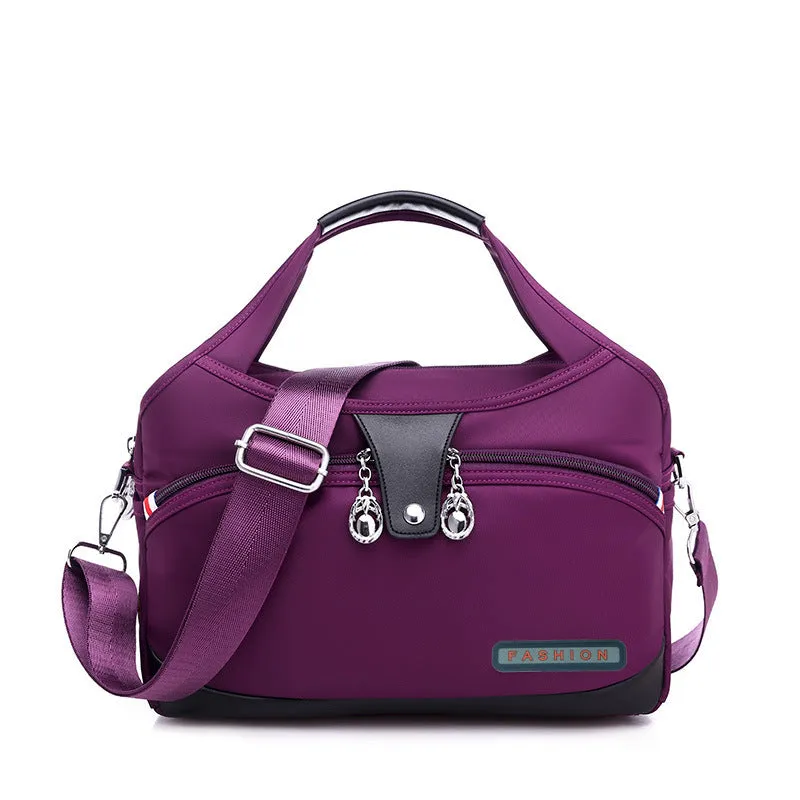 Women's crossbody bag in Oxford cloth with zippered closure and adjustable shoulder strap, 29cm long, available in multiple colours
