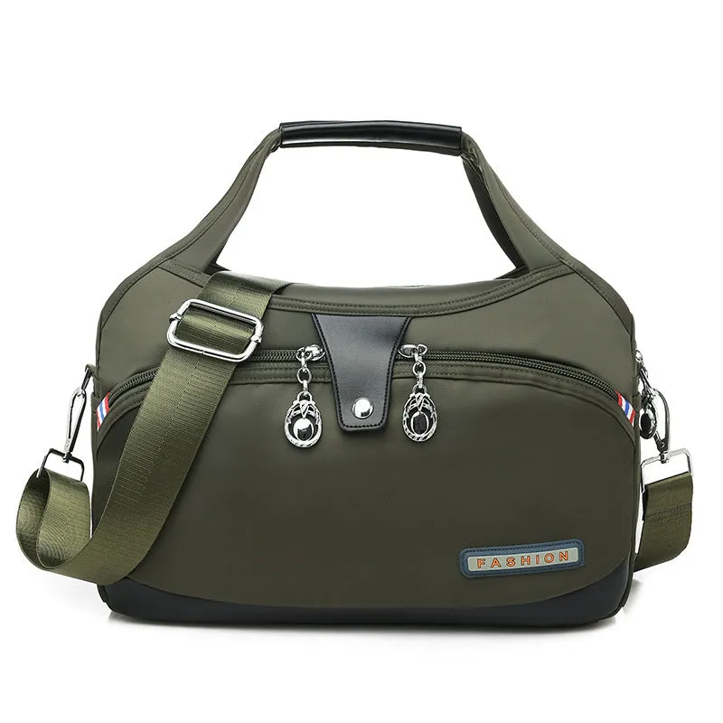 Women's crossbody bag in Oxford cloth with zippered closure and adjustable shoulder strap, 29cm long, available in multiple colours