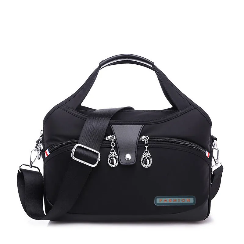 Women's crossbody bag in Oxford cloth with zippered closure and adjustable shoulder strap, 29cm long, available in multiple colours