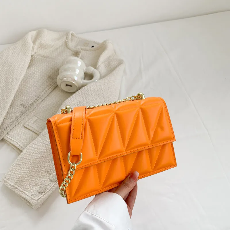 Small square PU chain crossbody bag in horizontal shape with spliced detail, available in five colours.