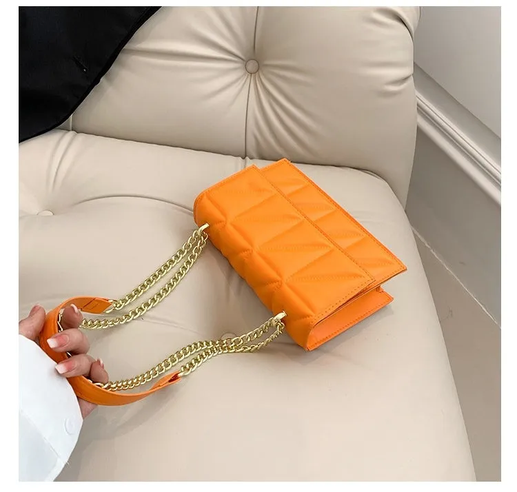 Small square PU chain crossbody bag in horizontal shape with spliced detail, available in five colours.