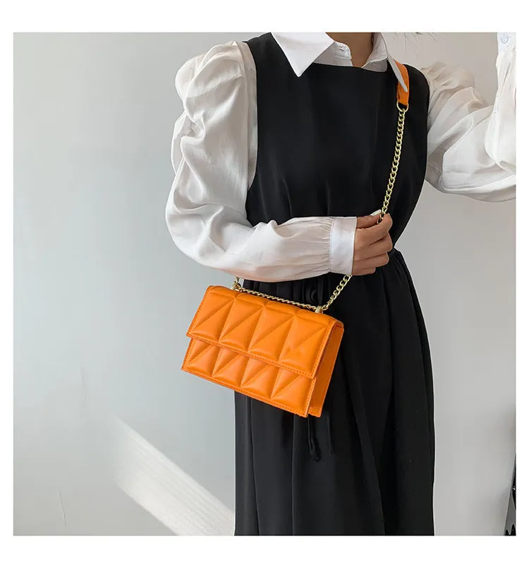Small square PU chain crossbody bag in horizontal shape with spliced detail, available in five colours.