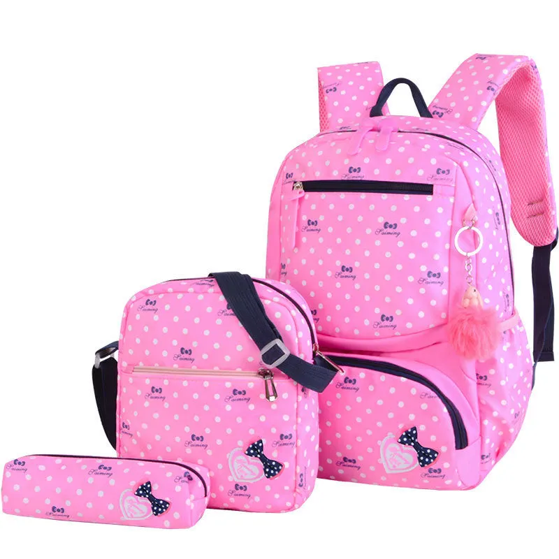 Elementary school girl Korean style cute princess backpack in light pink with polka dot bow pattern, waterproof nylon, reduced burden