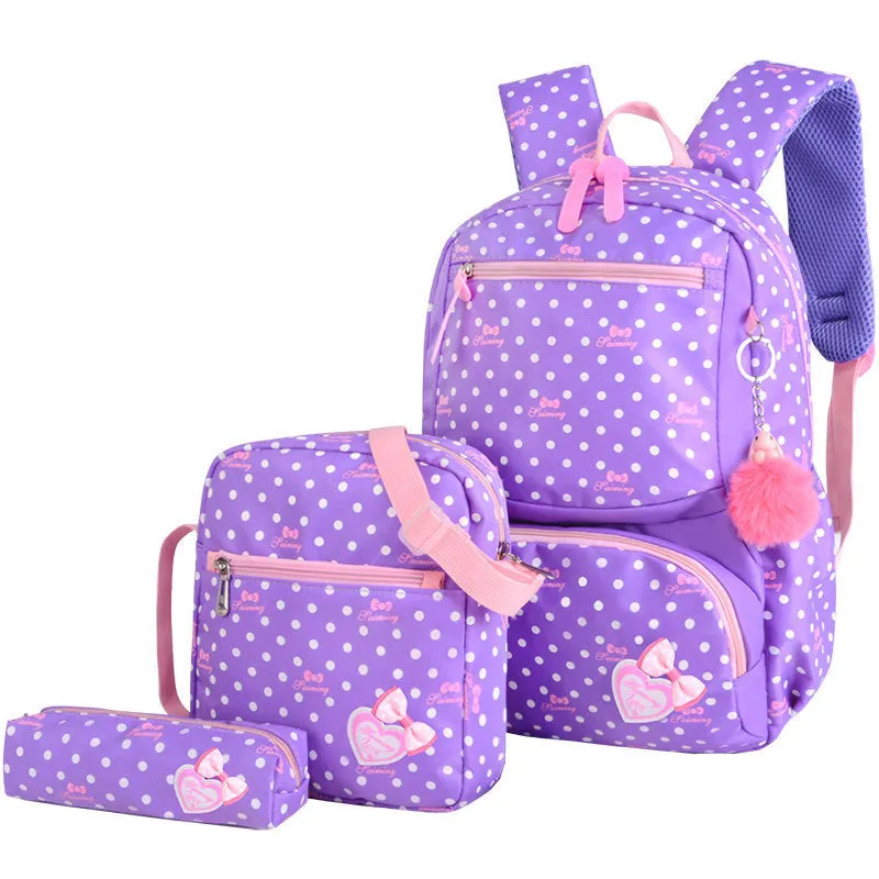 Elementary school girl Korean style cute princess backpack in light pink with polka dot bow pattern, waterproof nylon, reduced burden