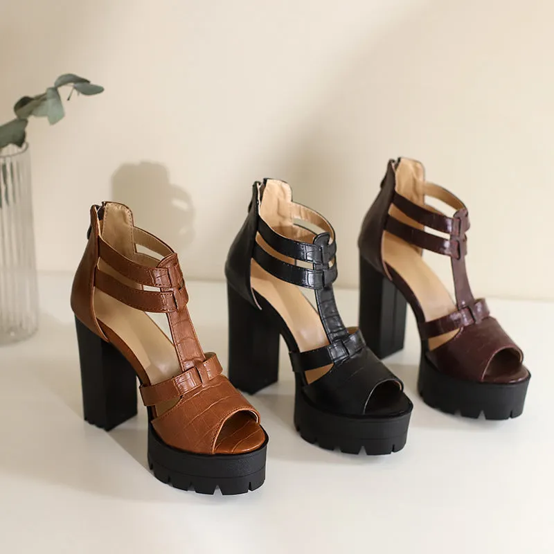 A pair of black platform high heel sandals with a back zipper and round toe on a rubber sole.