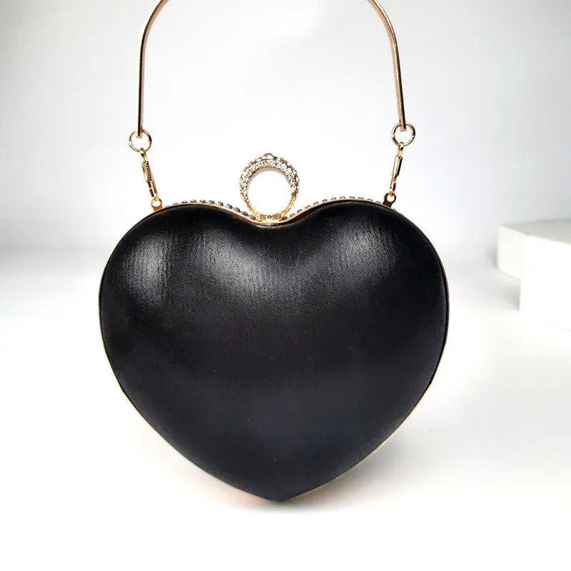 Women's heart-shaped metal dinner bag with tassel detail in black, gold, and silver options