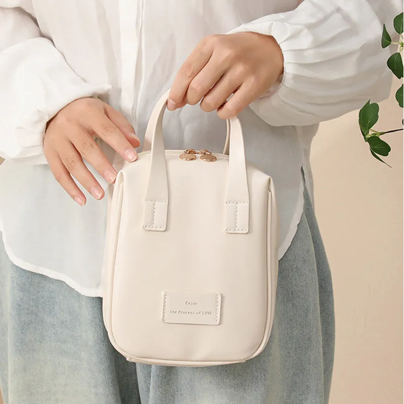 Handle-top cosmetic bag shell-shaped design in cream white with high capacity storage for travel and home use